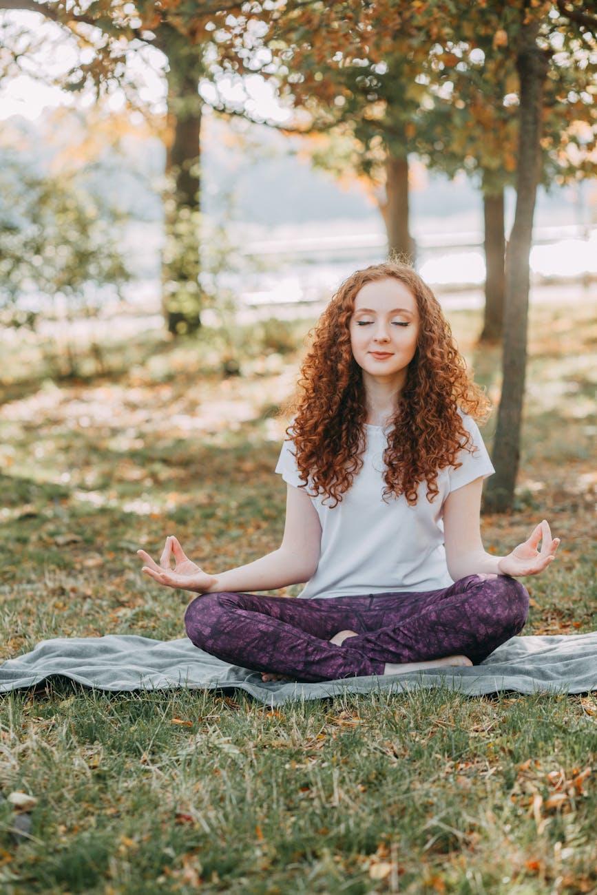 Woman meditating in Sukasana, easy seat.